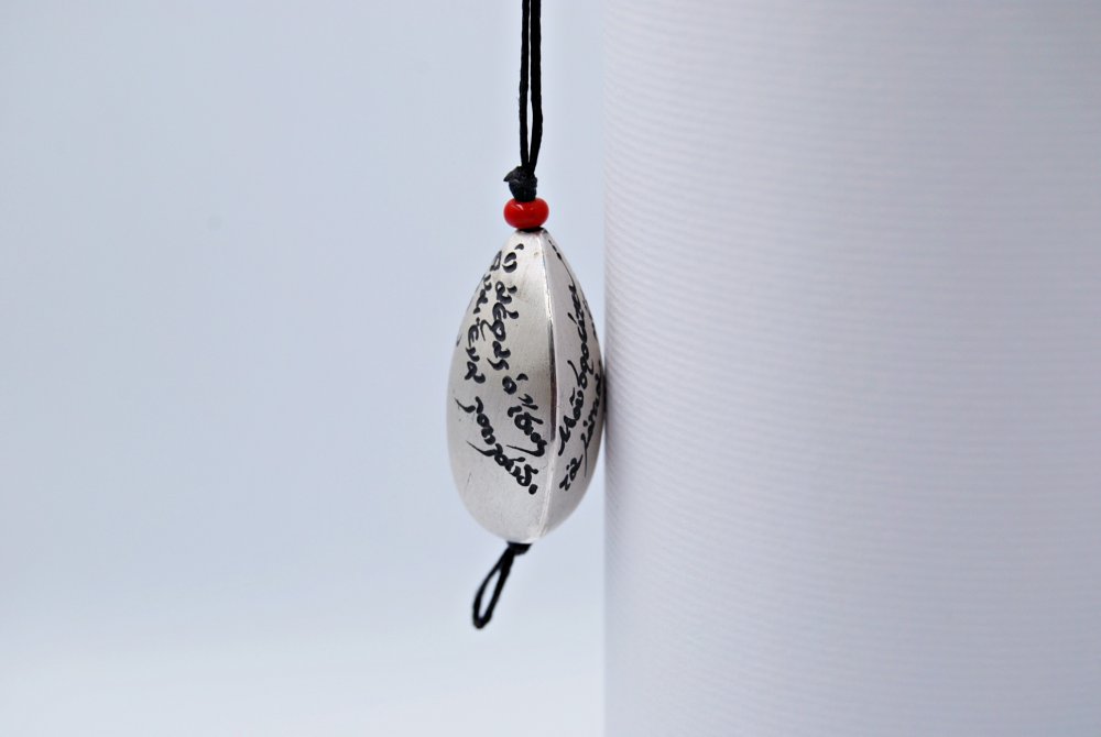 PENDANT <span>Silver with waxed cords and a red bead, small </span>
